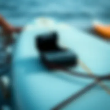 Close-up of a surfboard strap installed properly on a surfboard.