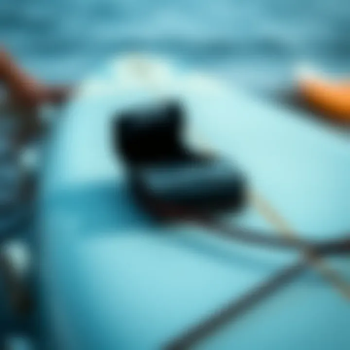 Close-up of a surfboard strap installed properly on a surfboard.