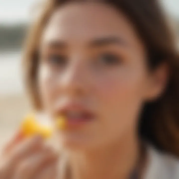 Application of lip balm during a beach outing, emphasizing sun protection.