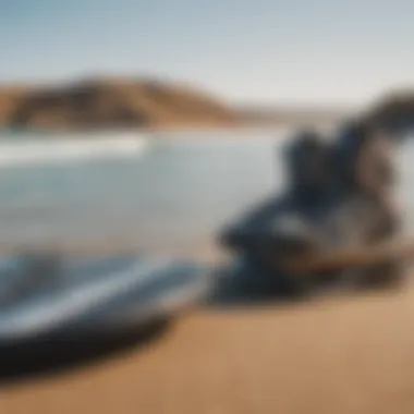 A collection of essential wakeboarding gear displayed on a sandy beach