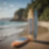 Different types of stand-up paddleboards displayed on a beach.