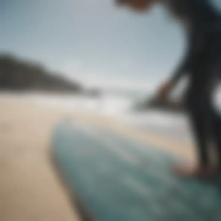 Surfer inspecting surfboard for damage