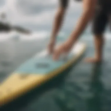 Installation demonstration of Dakine deck pad on a surfboard