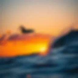 Surfer riding a wave at sunset