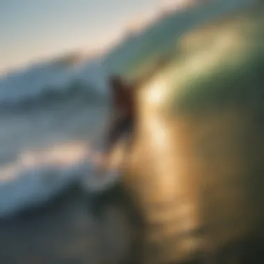 Aerial view of a surfer catching a wave at sunset