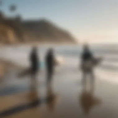 A group of surfers gathered on the beach preparing for the day