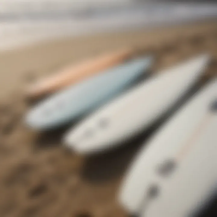 Close-up of surfboards lined up on the sandy beach