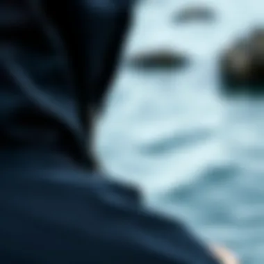 Close-up of the fabric and design of a black hooded poncho