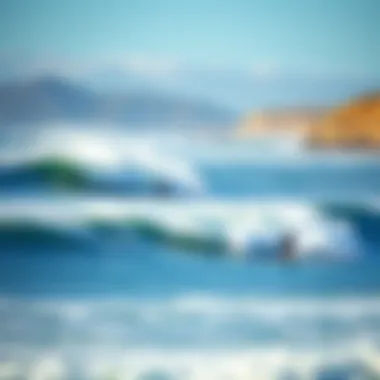 Surfers in the ocean with waves crashing and a beautiful coastline in the background