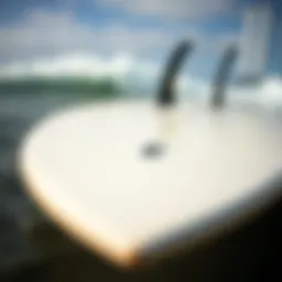 Close-up view of a high performance fish surfboard showcasing its sleek design and fin setup