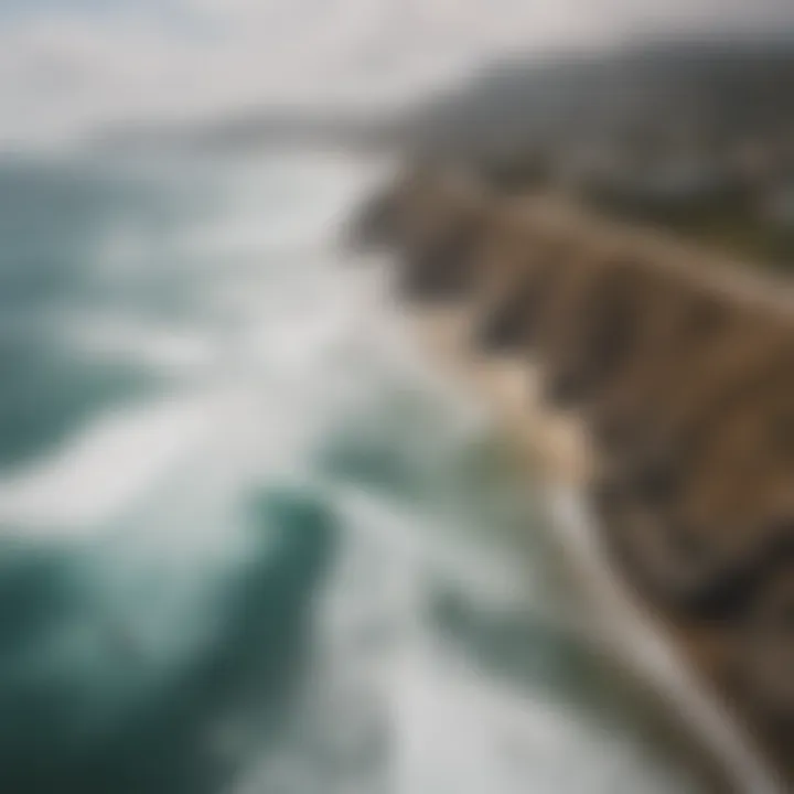 Aerial view of stunning coastline with surfers riding waves