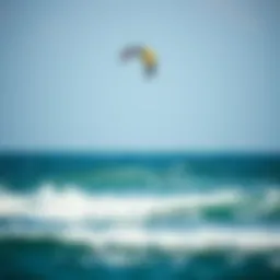 A kite soaring above the ocean waves during a kiteboarding session