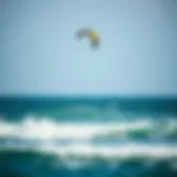 Kite Soaring Above Ocean Waves A kite soaring above the ocean waves during a kiteboarding session