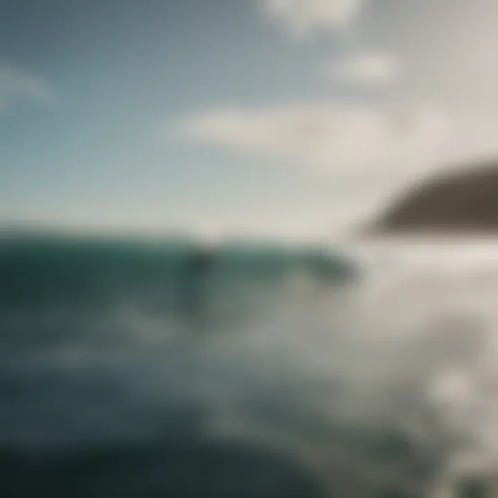 A scenic view of surfers riding waves with a distant coastline