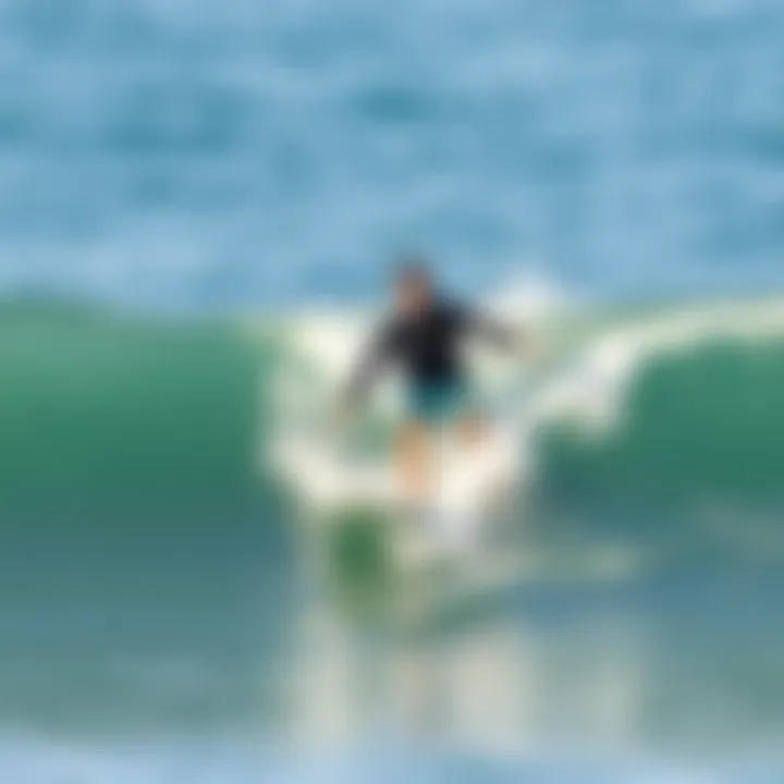 A surfer riding a soft top long surfboard on a gentle wave
