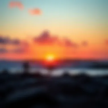 Vibrant sunset over the ocean with surfers in the foreground