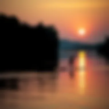 Paddleboarding at Dusk A stand-up paddleboarder gliding across a serene lake at sunset