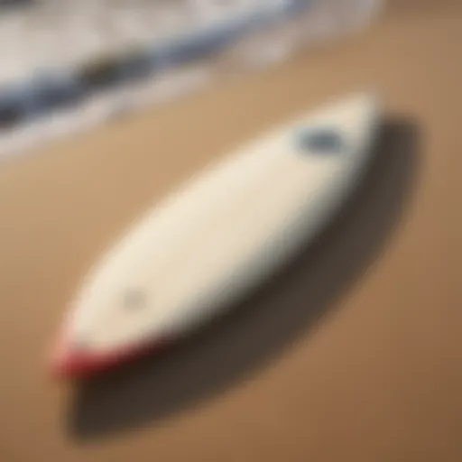 A vintage single fin surfboard resting on the sand, showcasing its classic design.