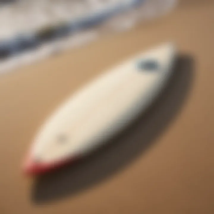 A vintage single fin surfboard resting on the sand, showcasing its classic design.