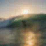 A surfer catching a wave at sunrise