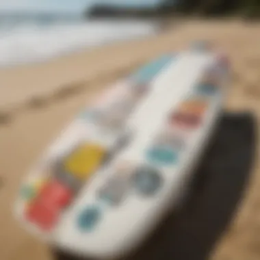 A surfboard adorned with colorful car stickers parked by the beach