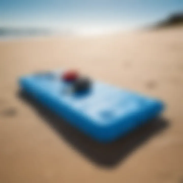 An inflatable boogie board resting on a sandy beach under a clear blue sky