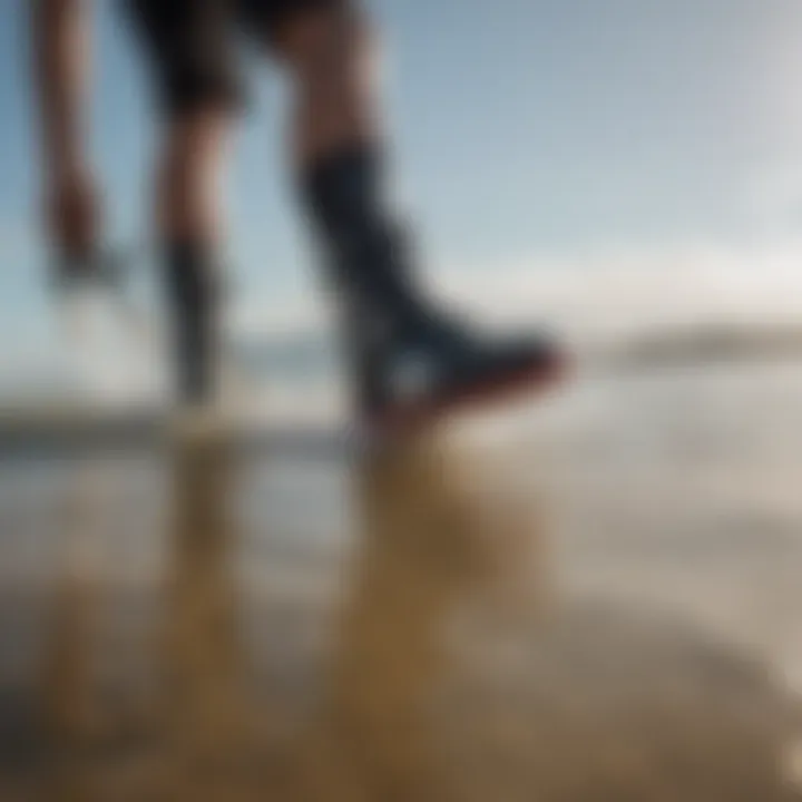 Kite surfer adjusting boots before entering the water