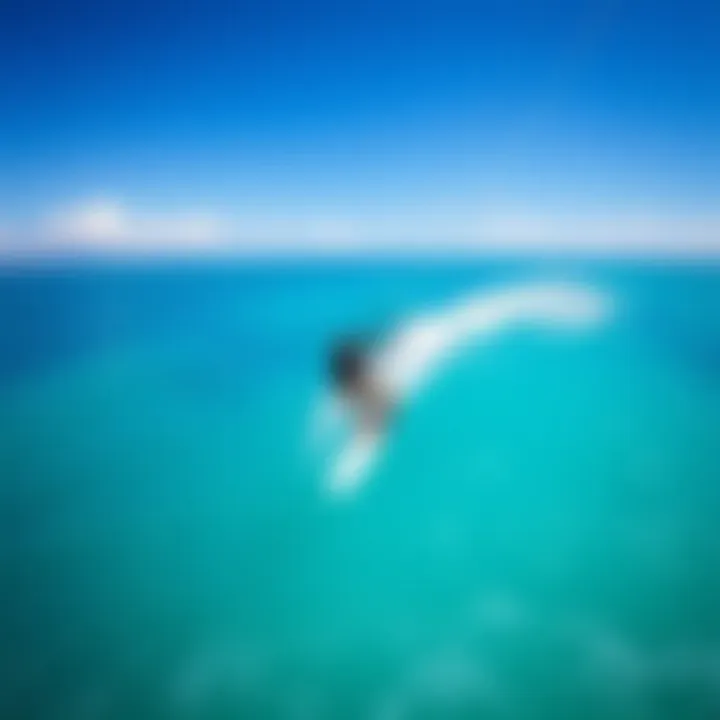 Aerial view of a kite surfer gliding over turquoise waters