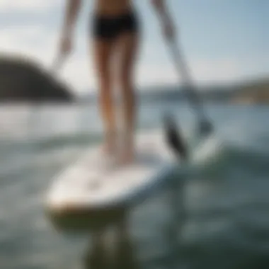 Paddleboarder maintaining balance on water