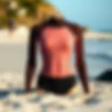 Stylish wetsuit top displayed on a sandy beach
