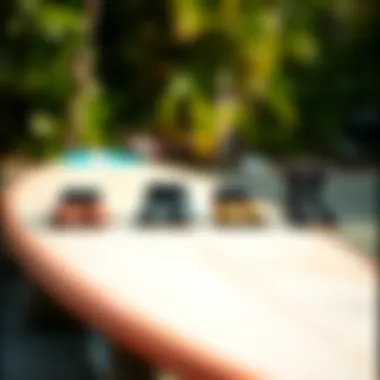 Comparison of different sizes of Ripcurl booties laid out on a surfboard