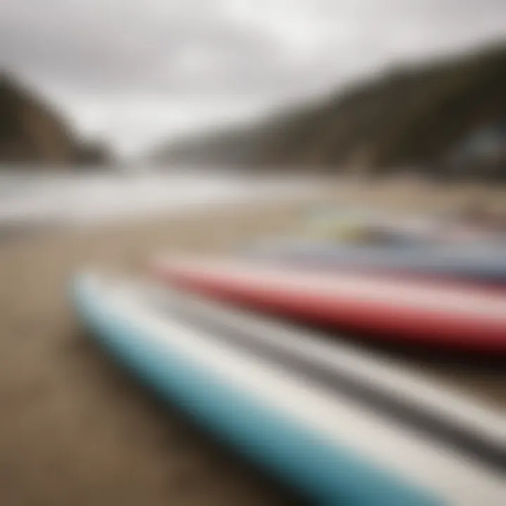 Close-up of surfboards lined up on the beach