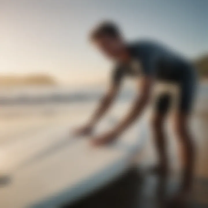 Surfer applying wax to a surfboard