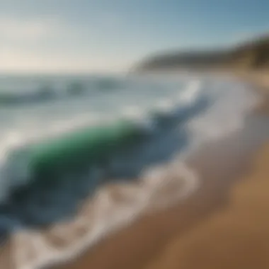 A serene beach setting with surfers in the distance