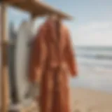 A stylish surfing robe hanging on a beachside rack