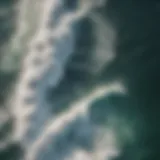 Aerial view of massive surf waves crashing on a rocky coastline