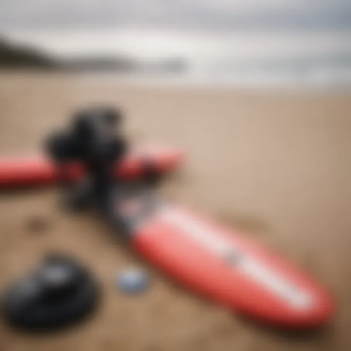 Essential surfing gear laid out on a sandy beach.