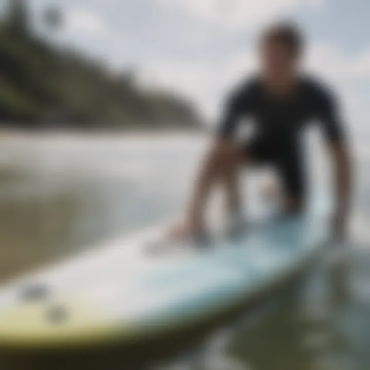 Surfer demonstrating the application of a traction pad on a surfboard