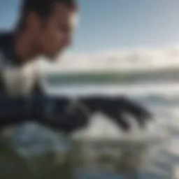 Close-up of a surfer wearing mittens in cold water