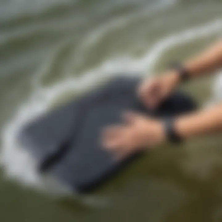 Close-up of a boogie board wrist leash attached to a board in water