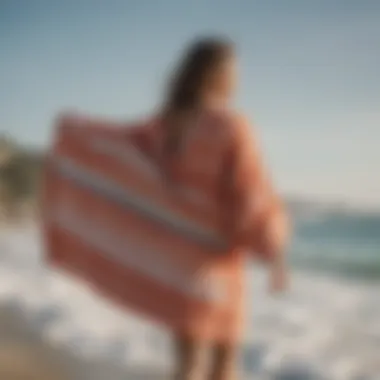 Person wearing a surfing towel robe on the beach