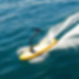 A sleek electric foil board gliding over clear blue water