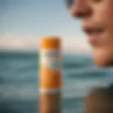 Close-up of Vertra sunscreen stick with ocean in background